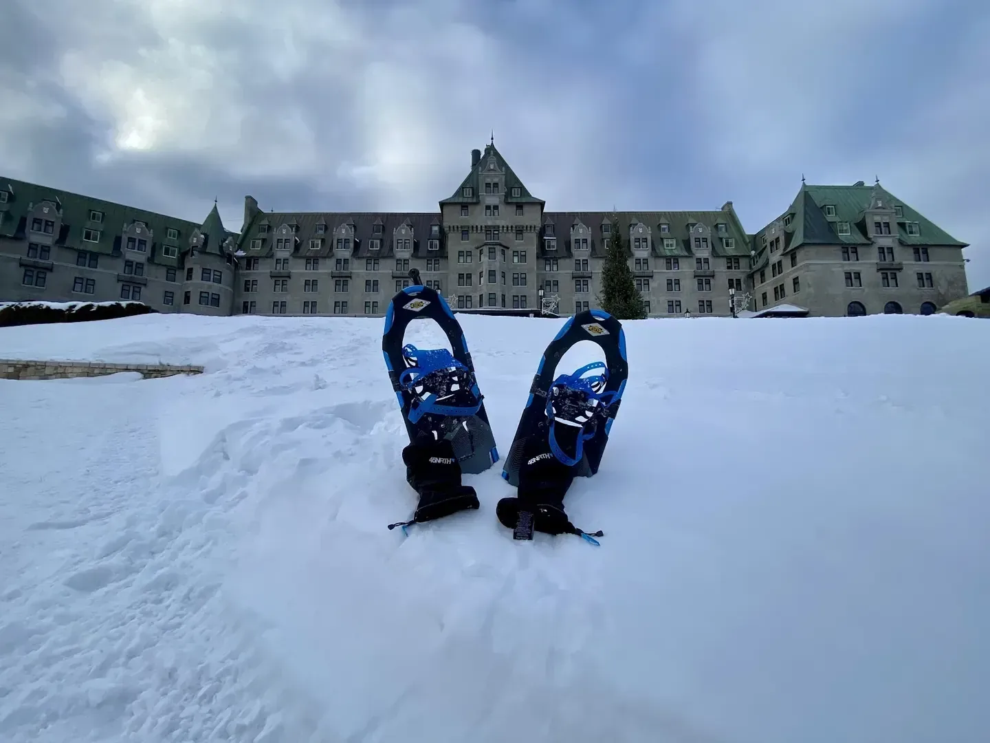 The chateau-style main building of Fairmont Le Manoir Richelieu in La Malbaie, seen across a snow-covered lawn